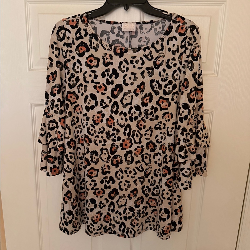Zadie B’s leopard print ruffle sleeve blouse.